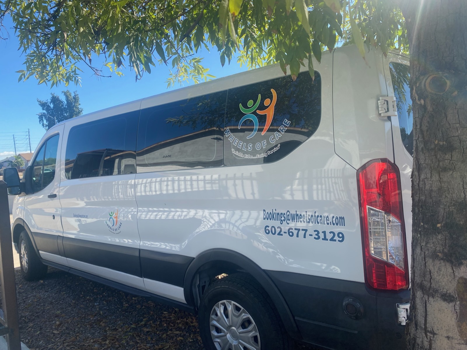 A white van with logo og WOC.