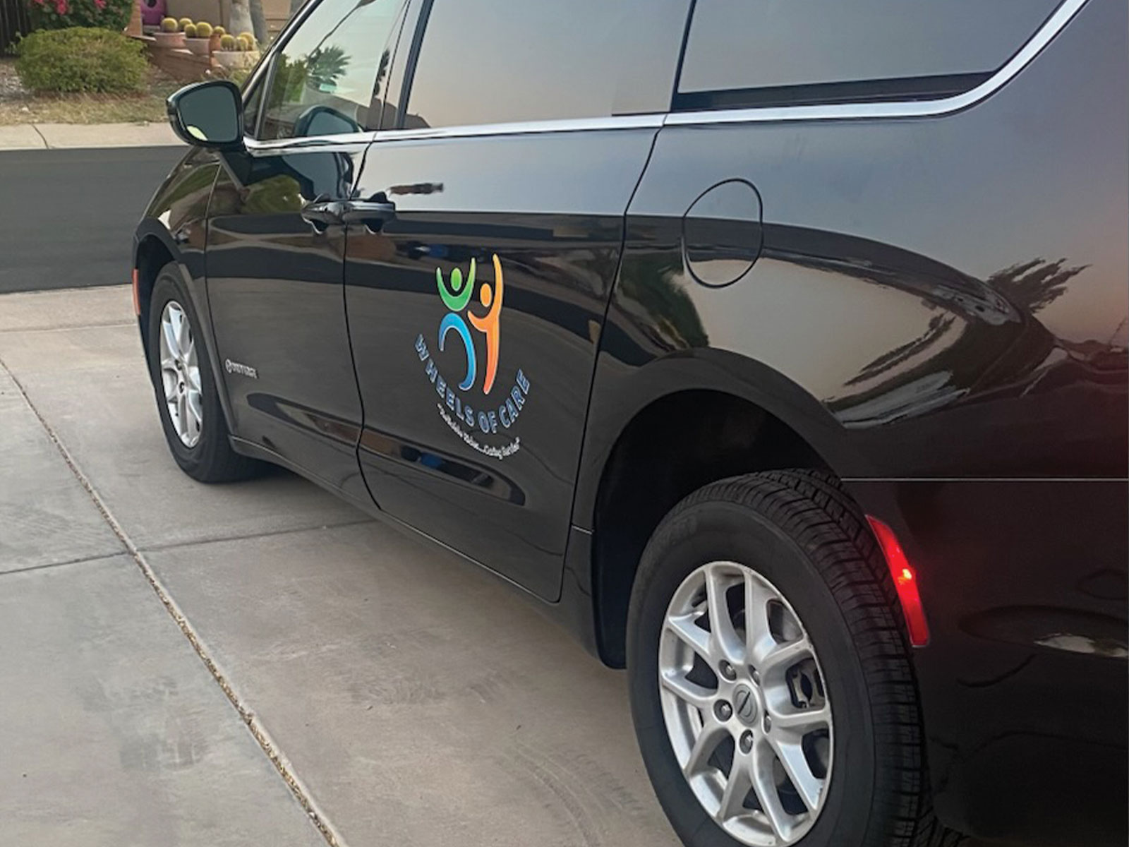 A black car and a logo of WOC.